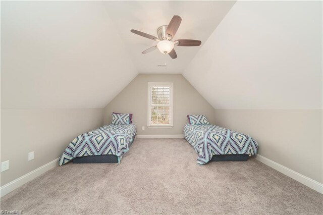 unfurnished bedroom with a ceiling fan, carpet, vaulted ceiling, and baseboards