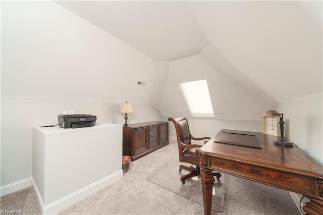 office area with vaulted ceiling, light colored carpet, and baseboards