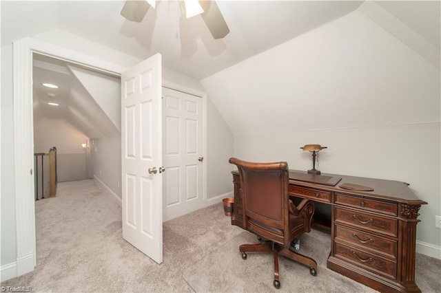 carpeted home office with lofted ceiling, ceiling fan, and baseboards