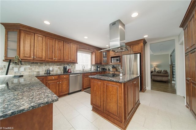 kitchen featuring stainless steel appliances, island exhaust hood, brown cabinets, decorative backsplash, and recessed lighting