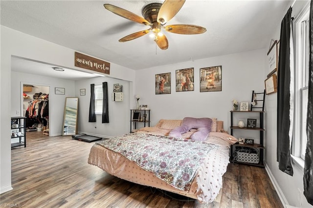 267 Pine Ridge Trl, Pinnacle, NC 27043 - bedroom featuring wood finished floors, a walk in closet, and a ceiling fan