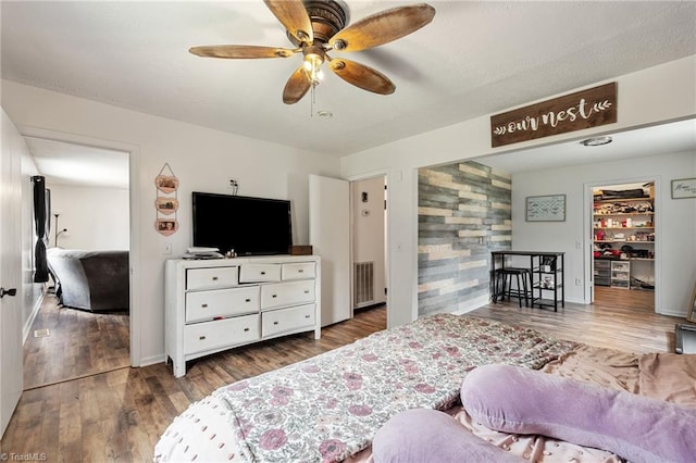 267 Pine Ridge Trl, Pinnacle, NC 27043 - bedroom featuring wood finished floors, ceiling fan, and a walk in closet