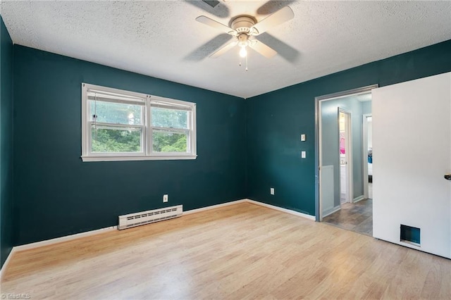 267 Pine Ridge Trl, Pinnacle, NC 27043 - empty room with a baseboard heating unit, wood finished floors, a textured ceiling, and ceiling fan