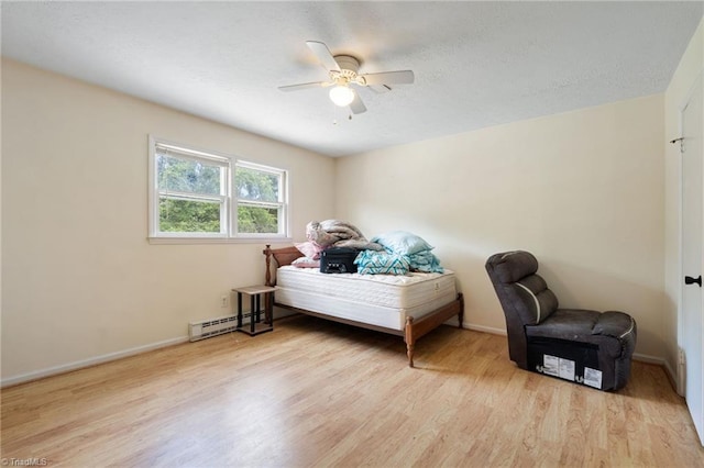 267 Pine Ridge Trl, Pinnacle, NC 27043 - bedroom with a baseboard heating unit, light wood-style floors, and ceiling fan