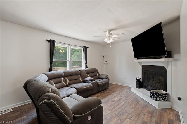 267 Pine Ridge Trl, Pinnacle, NC 27043 - living room featuring a ceiling fan, a fireplace with raised hearth, and wood finished floors