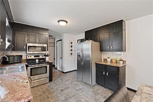 267 Pine Ridge Trl, Pinnacle, NC 27043 - kitchen featuring stainless steel appliances, backsplash, a textured ceiling, and stone finish floors