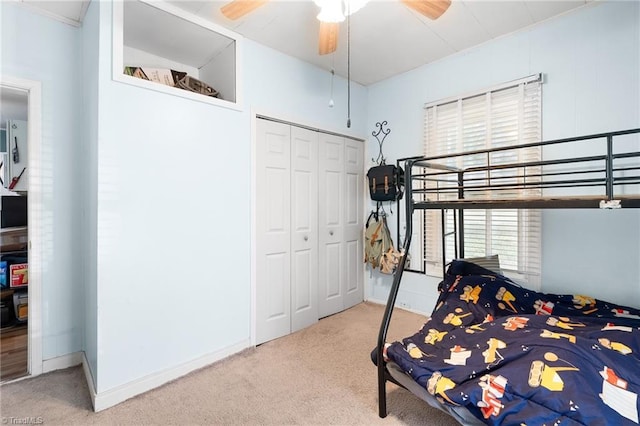 carpeted bedroom featuring a closet, a ceiling fan, and baseboards