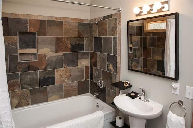 bathroom with shower / bath combo and sink