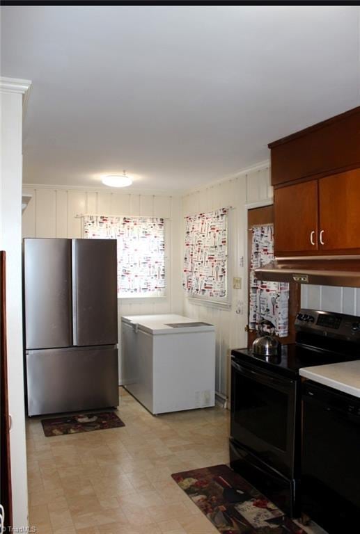 kitchen featuring stainless steel appliances, light floors, light countertops, and under cabinet range hood