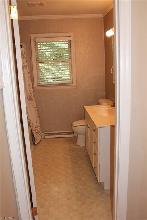 bathroom with a baseboard radiator, toilet, visible vents, vanity, and ornamental molding