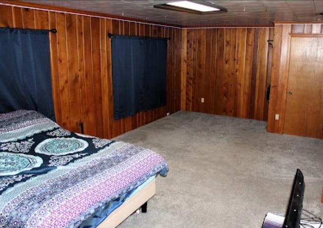 carpeted bedroom featuring wooden walls