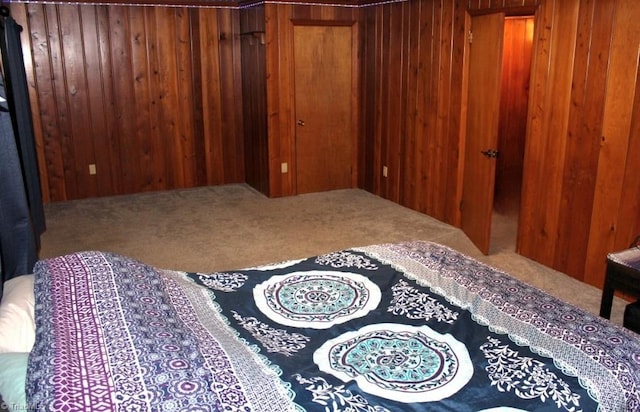 carpeted bedroom with wooden walls