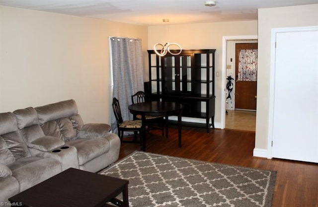 living room featuring dark hardwood / wood-style flooring and a chandelier