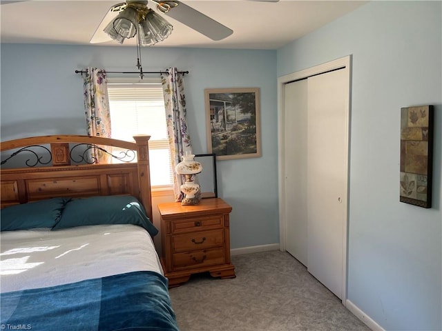 bedroom featuring a closet, light colored carpet, and ceiling fan