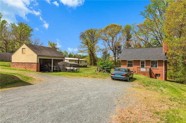 4478 Ogburn Ave, Winston-Salem, NC 27105 - view of front of house with brick siding, a front lawn, driveway, and a chimney