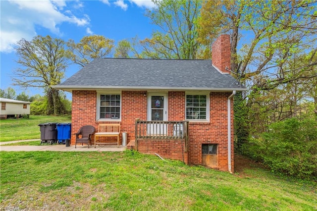 4478 Ogburn Ave, Winston-Salem, NC 27105 - exterior space featuring a shingled roof, a patio area, a chimney, brick siding, and a front lawn