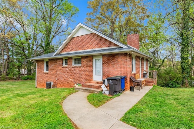 4478 Ogburn Ave, Winston-Salem, NC 27105 - exterior space featuring a chimney, a yard, central AC unit, and brick siding