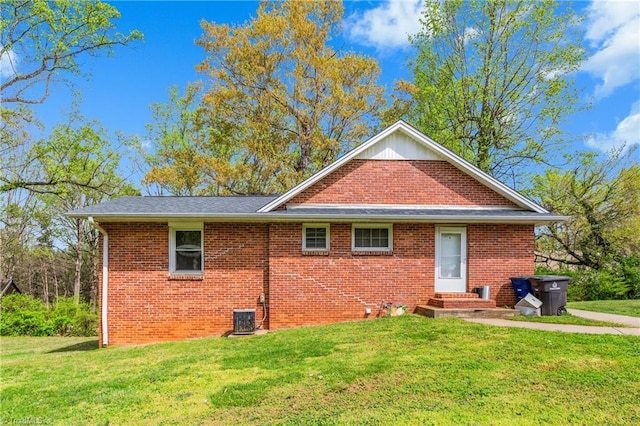 4478 Ogburn Ave, Winston-Salem, NC 27105 - view of front of house with entry steps, a front yard, central AC unit, and brick siding