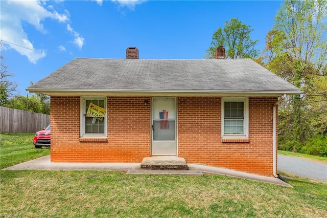 4478 Ogburn Ave, Winston-Salem, NC 27105 - view of front of property featuring a front yard, fence, brick siding, and a chimney