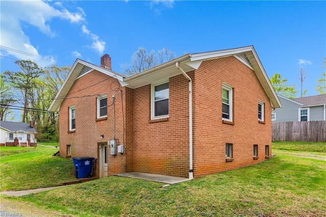 4478 Ogburn Ave, Winston-Salem, NC 27105 - view of property exterior featuring fence, a yard, brick siding, and a chimney