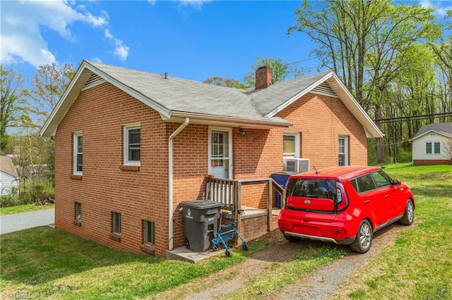 4478 Ogburn Ave, Winston-Salem, NC 27105 - view of home's exterior featuring a chimney, a lawn, and brick siding