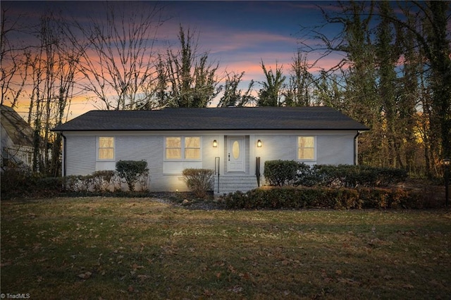 ranch-style house featuring a yard