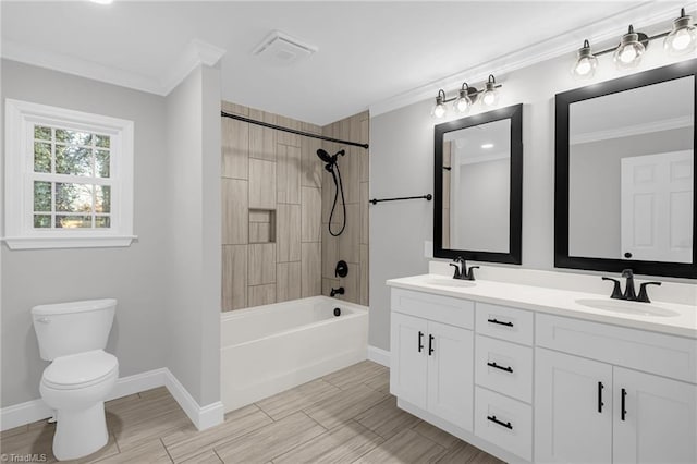 full bathroom featuring vanity, ornamental molding, toilet, and tiled shower / bath