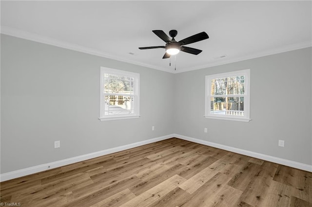 empty room with ceiling fan, ornamental molding, and light wood-type flooring