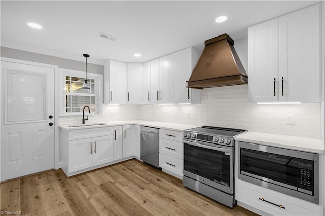 kitchen featuring stainless steel appliances, sink, custom exhaust hood, and white cabinets