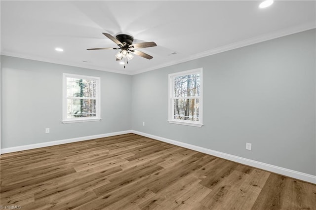 spare room featuring wood-type flooring, ornamental molding, and ceiling fan