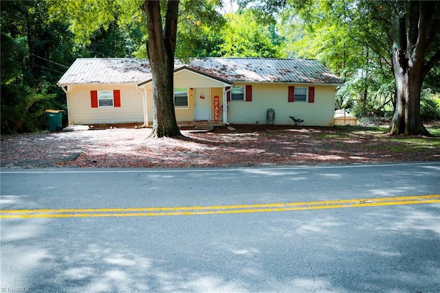 ranch-style home featuring metal roof