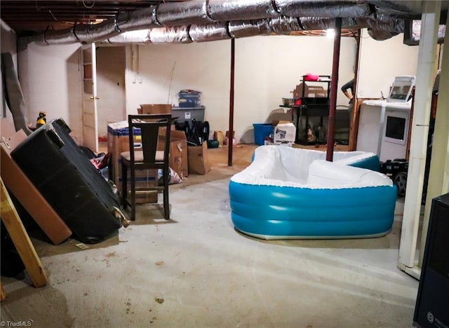 unfinished basement featuring washer / dryer