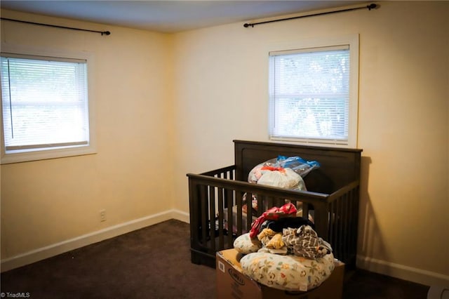 carpeted bedroom featuring baseboards