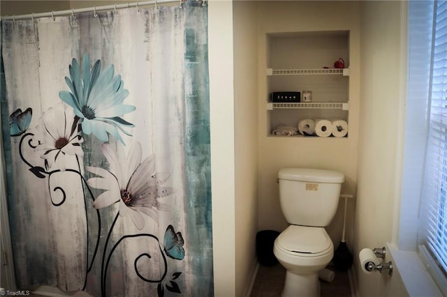 bathroom with tile patterned floors and toilet