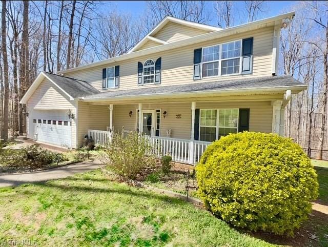 215 Blakes Ct, Thomasville, NC 27360 - view of front of home featuring an attached garage and covered porch