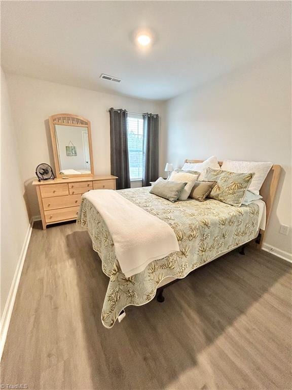 bedroom with wood-type flooring