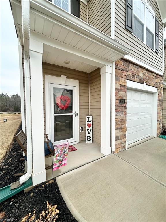 doorway to property with a garage