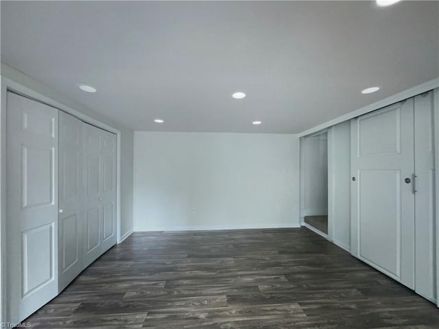 unfurnished bedroom with recessed lighting, a closet, and dark wood-style flooring