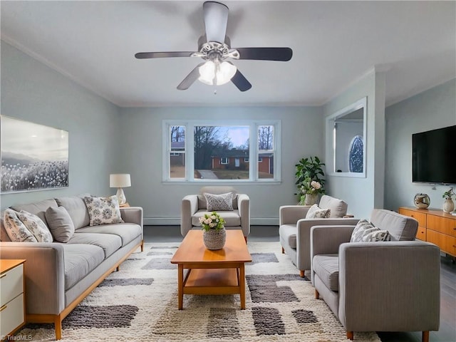 living area with baseboard heating and a ceiling fan