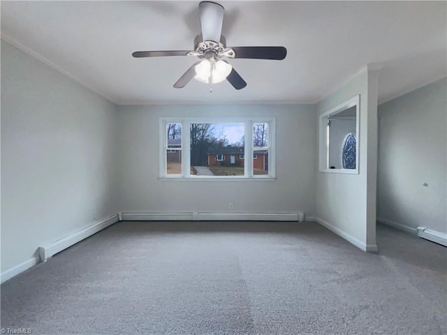 carpeted spare room featuring baseboards and a ceiling fan