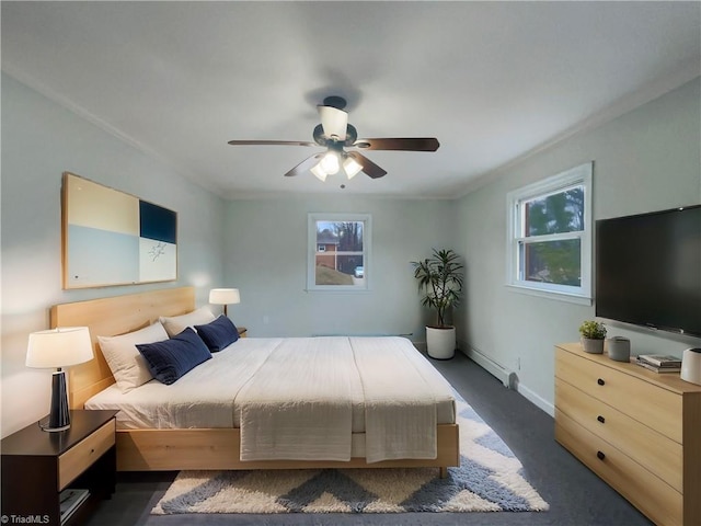 bedroom with ceiling fan, multiple windows, baseboards, and baseboard heating