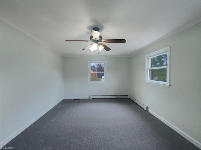 spare room with a baseboard heating unit, dark colored carpet, baseboards, and a ceiling fan