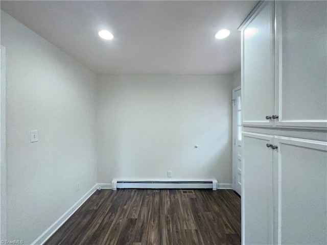 spare room featuring dark wood-style floors, recessed lighting, a baseboard radiator, and baseboards