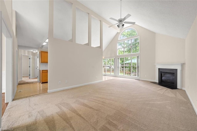 145 Millers Crossing Ct, Winston-Salem, NC 27103 - unfurnished living room with light carpet, high vaulted ceiling, a fireplace with flush hearth, and a ceiling fan
