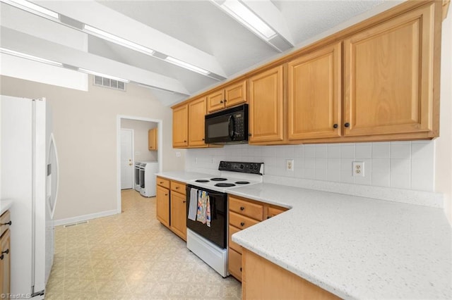 145 Millers Crossing Ct, Winston-Salem, NC 27103 - kitchen with white appliances, washer / clothes dryer, light flooring, vaulted ceiling, and backsplash