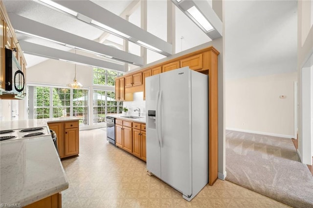 145 Millers Crossing Ct, Winston-Salem, NC 27103 - kitchen with white fridge with ice dispenser, dishwasher, high vaulted ceiling, light floors, and decorative light fixtures