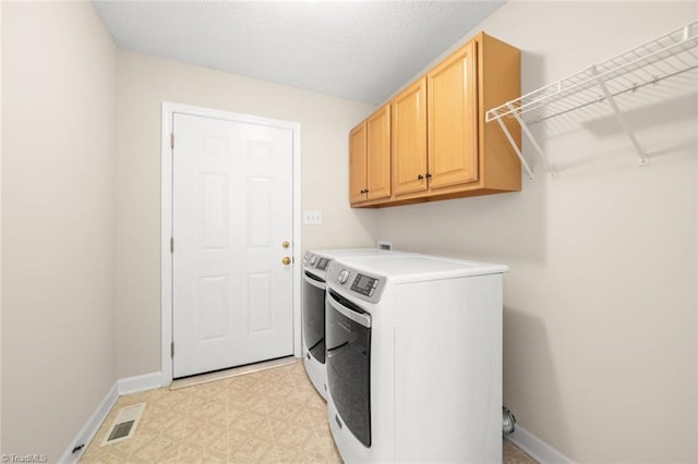 145 Millers Crossing Ct, Winston-Salem, NC 27103 - laundry room with washer and dryer, light floors, and cabinet space