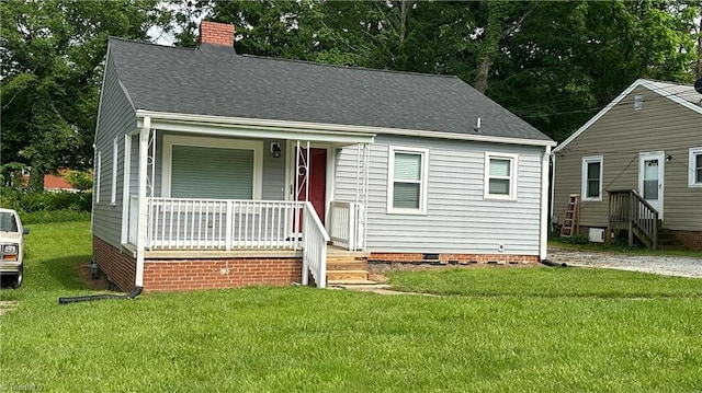 1004 Tabor St, High Point, NC 27262 - view of front of home featuring a porch, crawl space, a chimney, a front lawn, and roof with shingles