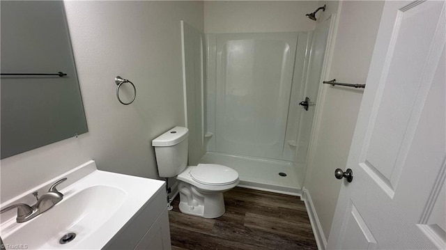 1004 Tabor St, High Point, NC 27262 - bathroom with wood finished floors, vanity, a shower, and toilet
