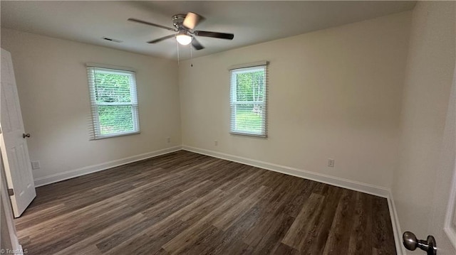 1004 Tabor St, High Point, NC 27262 - unfurnished room with healthy amount of natural light, dark wood-style flooring, ceiling fan, and baseboards